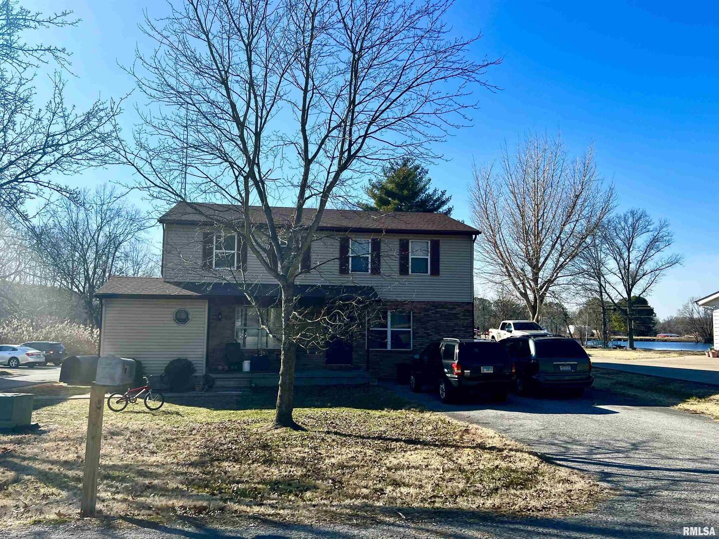 1609 South 22nd Street Herrin, IL 62948 - Photo 2 of 12 a front view of a house with yard covered with trees