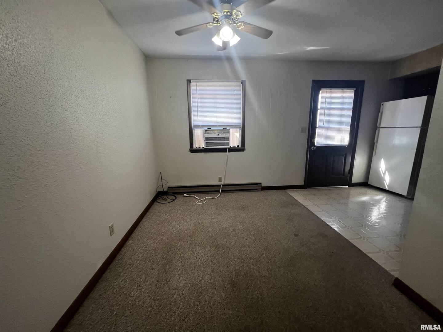 1609 South 22nd Street Herrin, IL 62948 - Photo 6 of 12 an empty room with a chandelier fan and windows