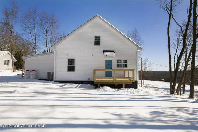 a view of the house with a snow in the background