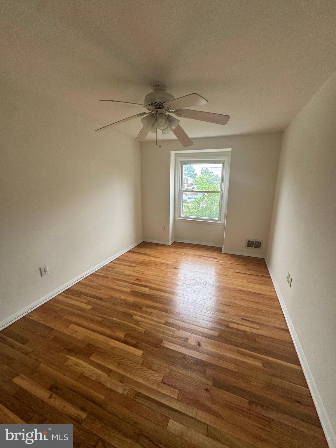2128 Cockspur Road Middle River, MD 21220 - Photo 10 of 28 wooden floor in an empty room with a window