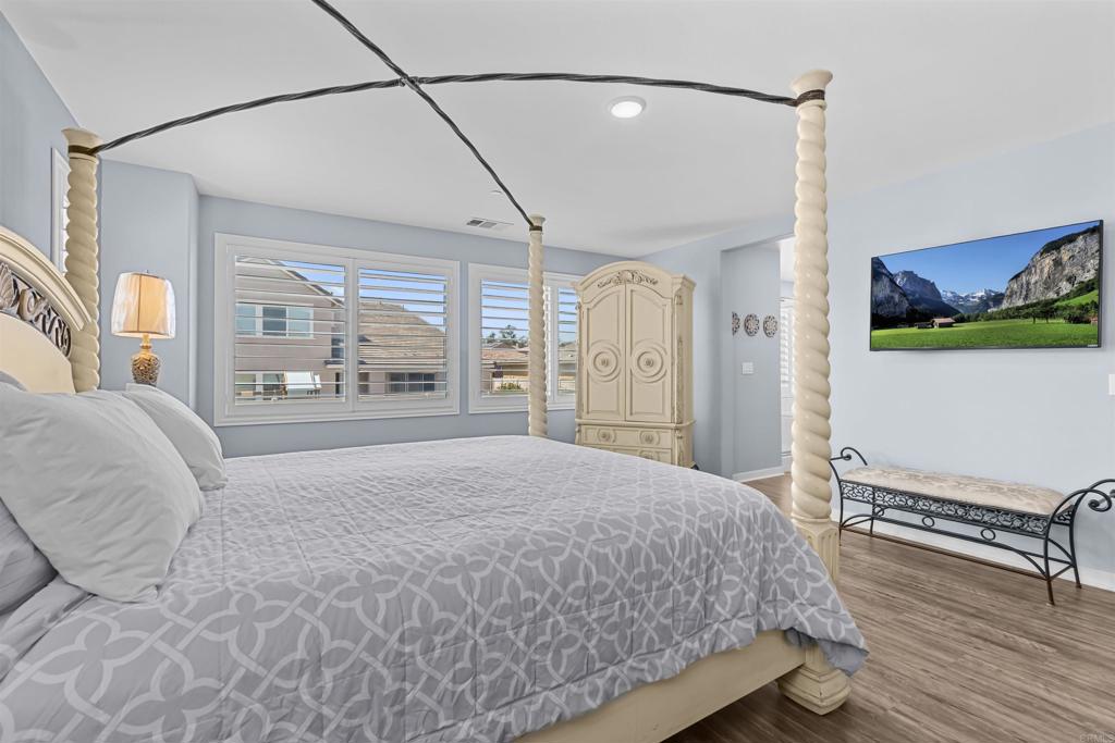 29809 Gypsy Vanner Way Menifee, CA 92584 - Photo 30 of 45 a bedroom with a large bed and a window