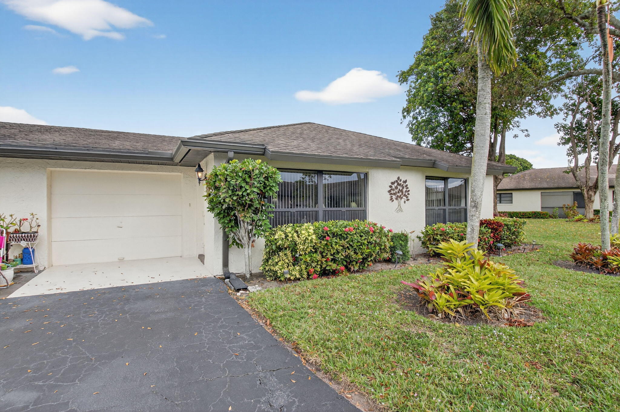 4972 Dovewood Road, Unit B Boynton Beach, FL 33436 - Photo 1 of 47 a front view of a house with garden