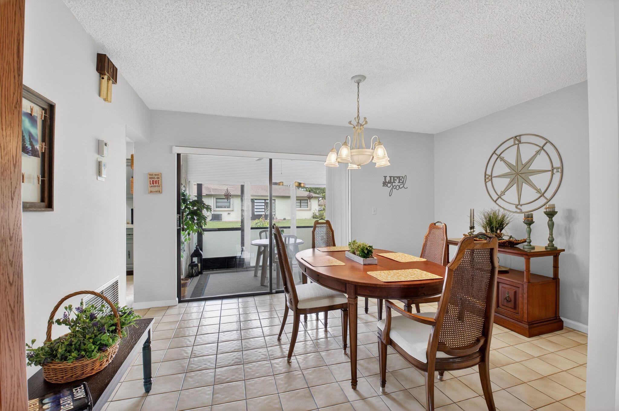 4972 Dovewood Road, Unit B Boynton Beach, FL 33436 - Photo 12 of 47 a view of a dining room with furniture and chandelier