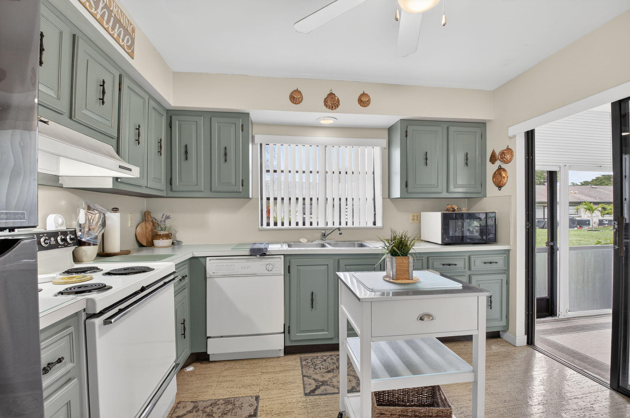 4972 Dovewood Road, Unit B Boynton Beach, FL 33436 - Photo 15 of 47 a kitchen with a sink stove and cabinets