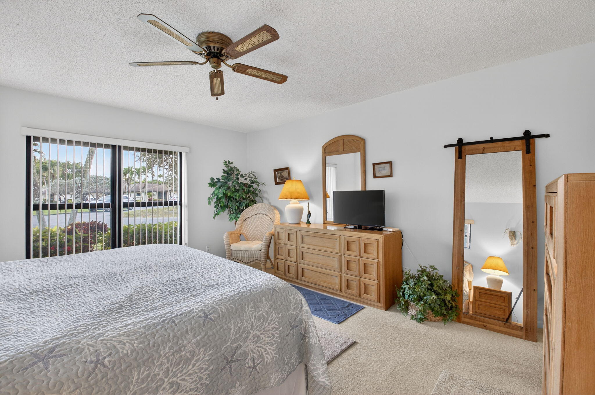 4972 Dovewood Road, Unit B Boynton Beach, FL 33436 - Photo 20 of 47 a bed room with a bed and a large window
