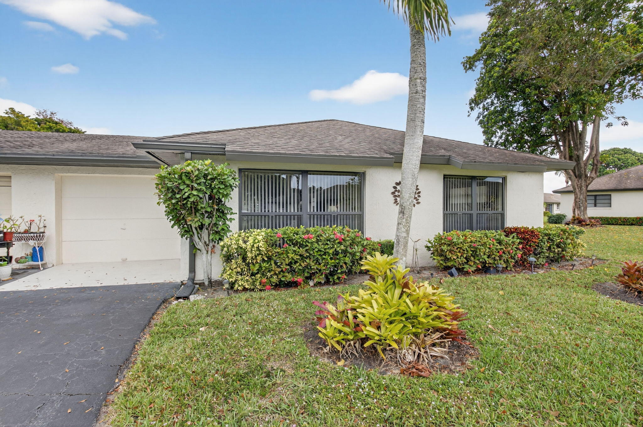 4972 Dovewood Road, Unit B Boynton Beach, FL 33436 - Photo 2 of 47 front view of a house with a yard