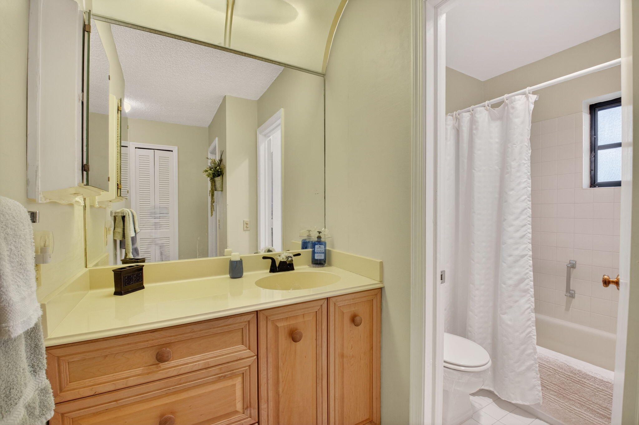 4972 Dovewood Road, Unit B Boynton Beach, FL 33436 - Photo 23 of 47 a bathroom with a sink and a mirror