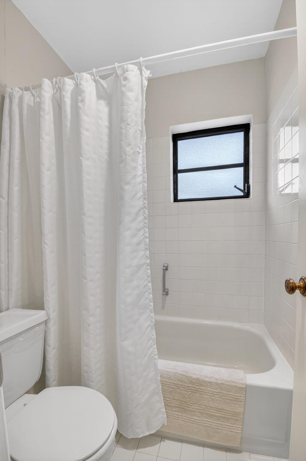 4972 Dovewood Road, Unit B Boynton Beach, FL 33436 - Photo 24 of 47 a bathroom with a toilet and a bathtub