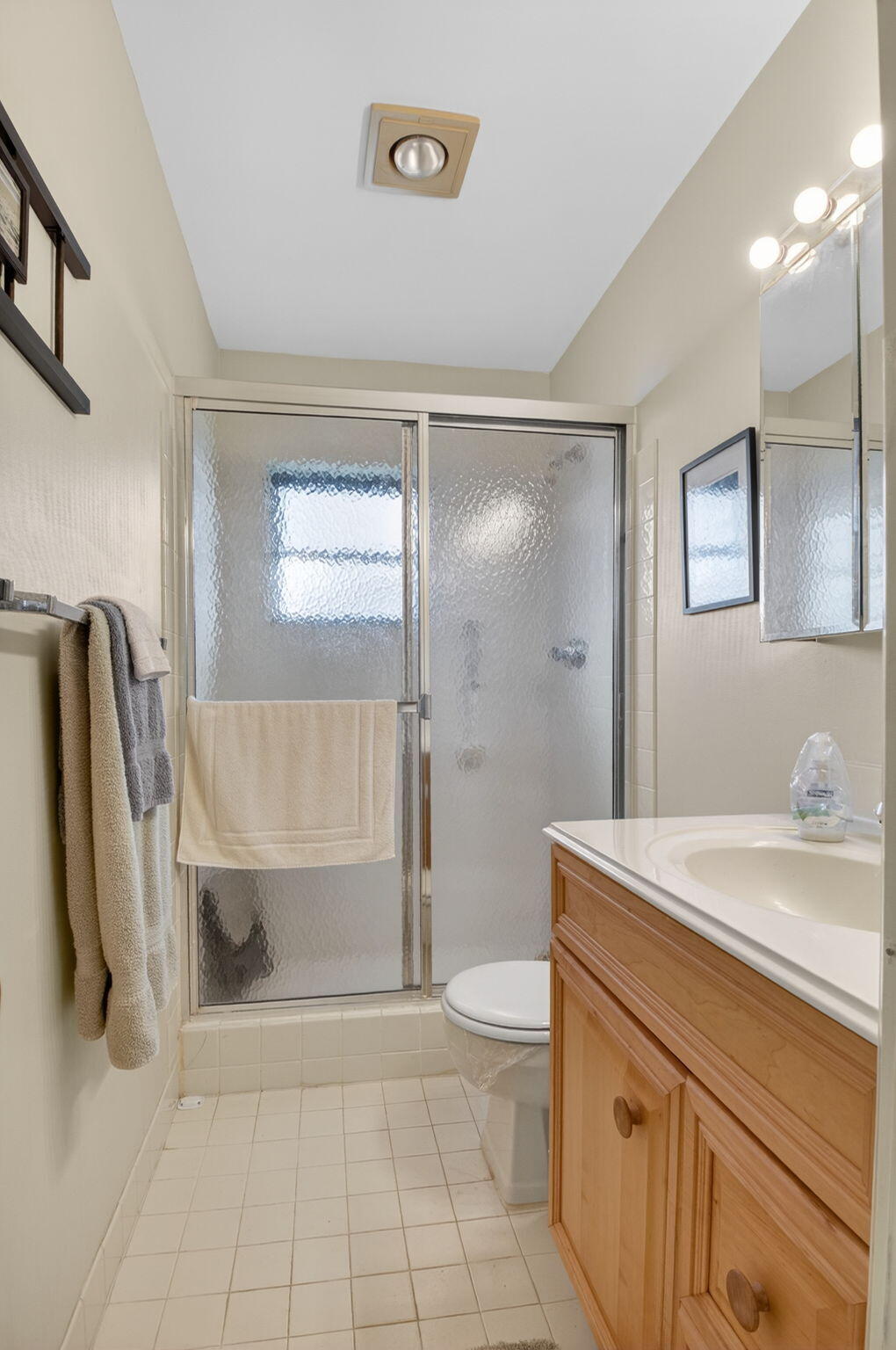 4972 Dovewood Road, Unit B Boynton Beach, FL 33436 - Photo 26 of 47 a bathroom with a sink a toilet and shower