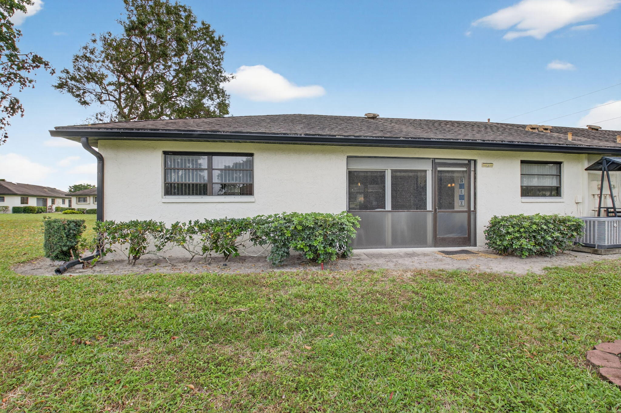 4972 Dovewood Road, Unit B Boynton Beach, FL 33436 - Photo 29 of 47 a front view of a house with a yard