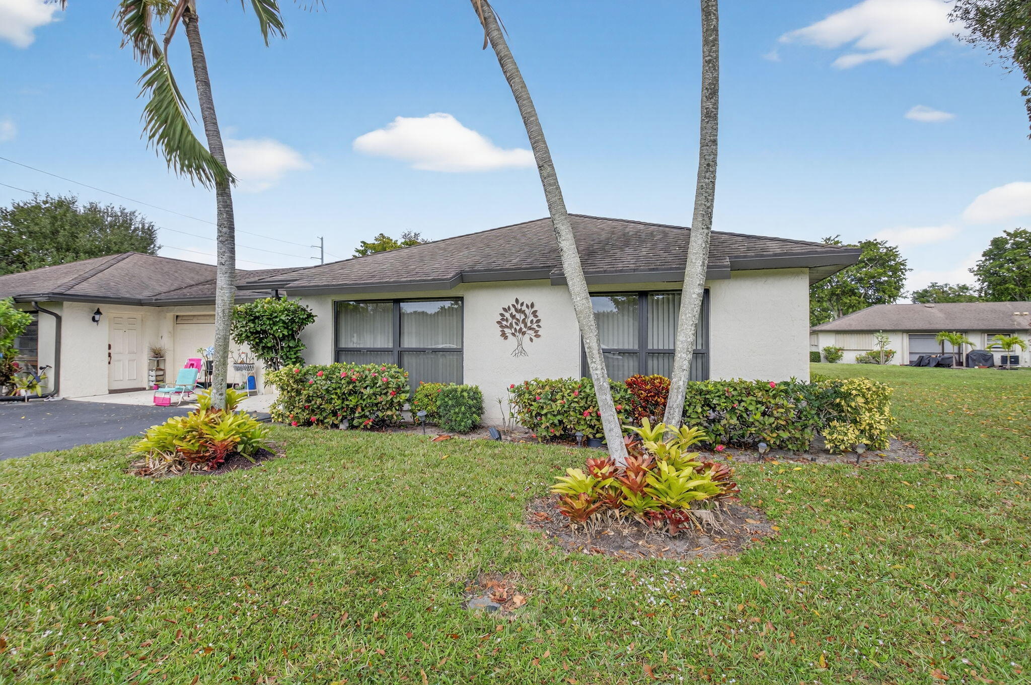 4972 Dovewood Road, Unit B Boynton Beach, FL 33436 - Photo 3 of 47 a front view of a house with garden
