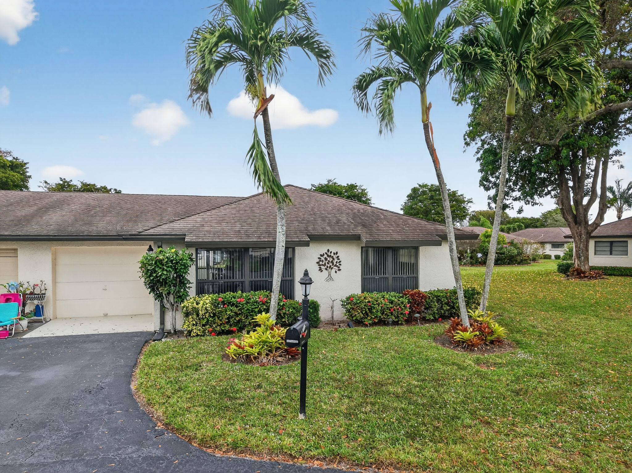 4972 Dovewood Road, Unit B Boynton Beach, FL 33436 - Photo 31 of 47 a view of a house with backyard and a tree