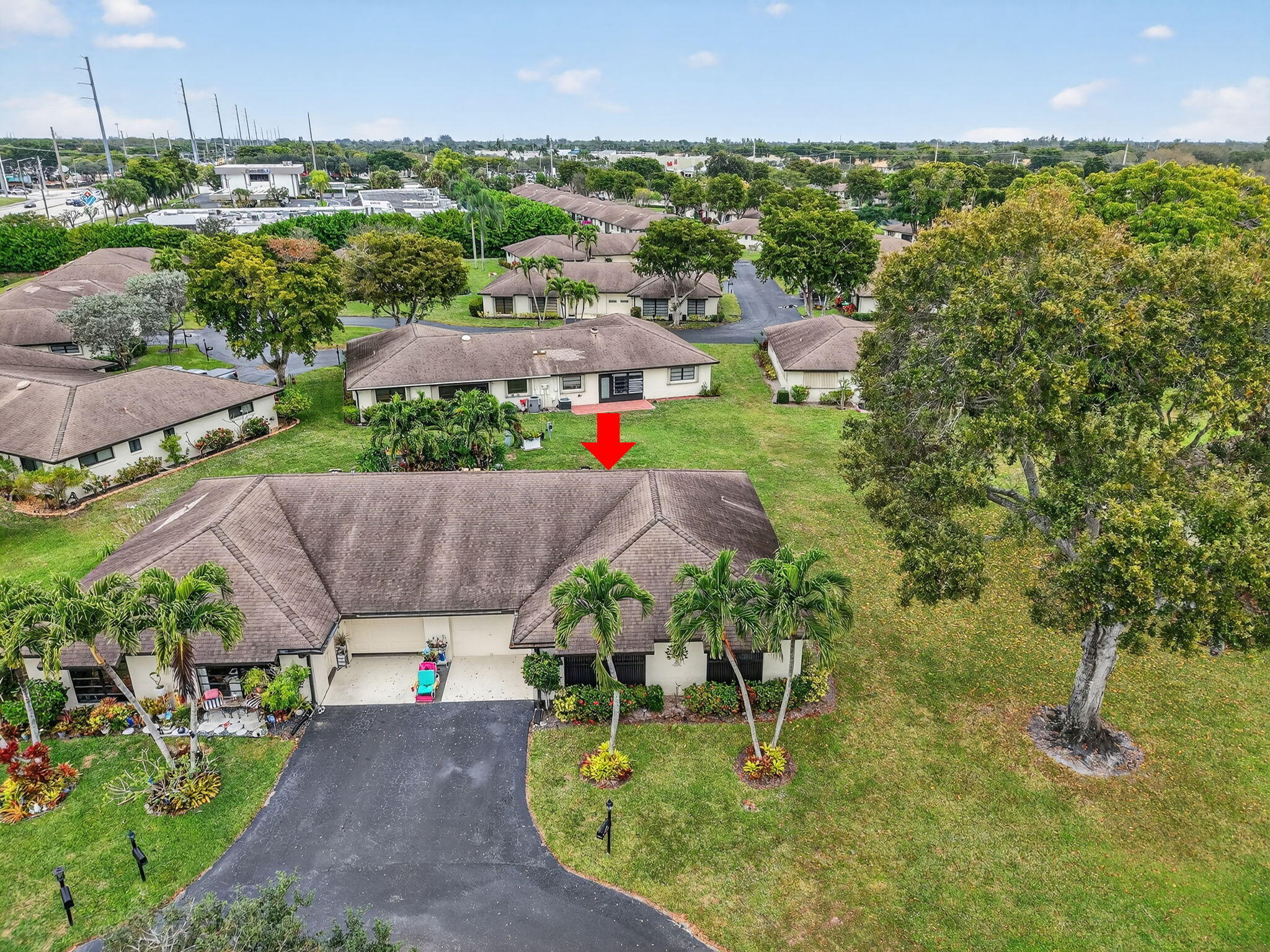 4972 Dovewood Road, Unit B Boynton Beach, FL 33436 - Photo 32 of 47 an aerial view of a house with a yard and lake view