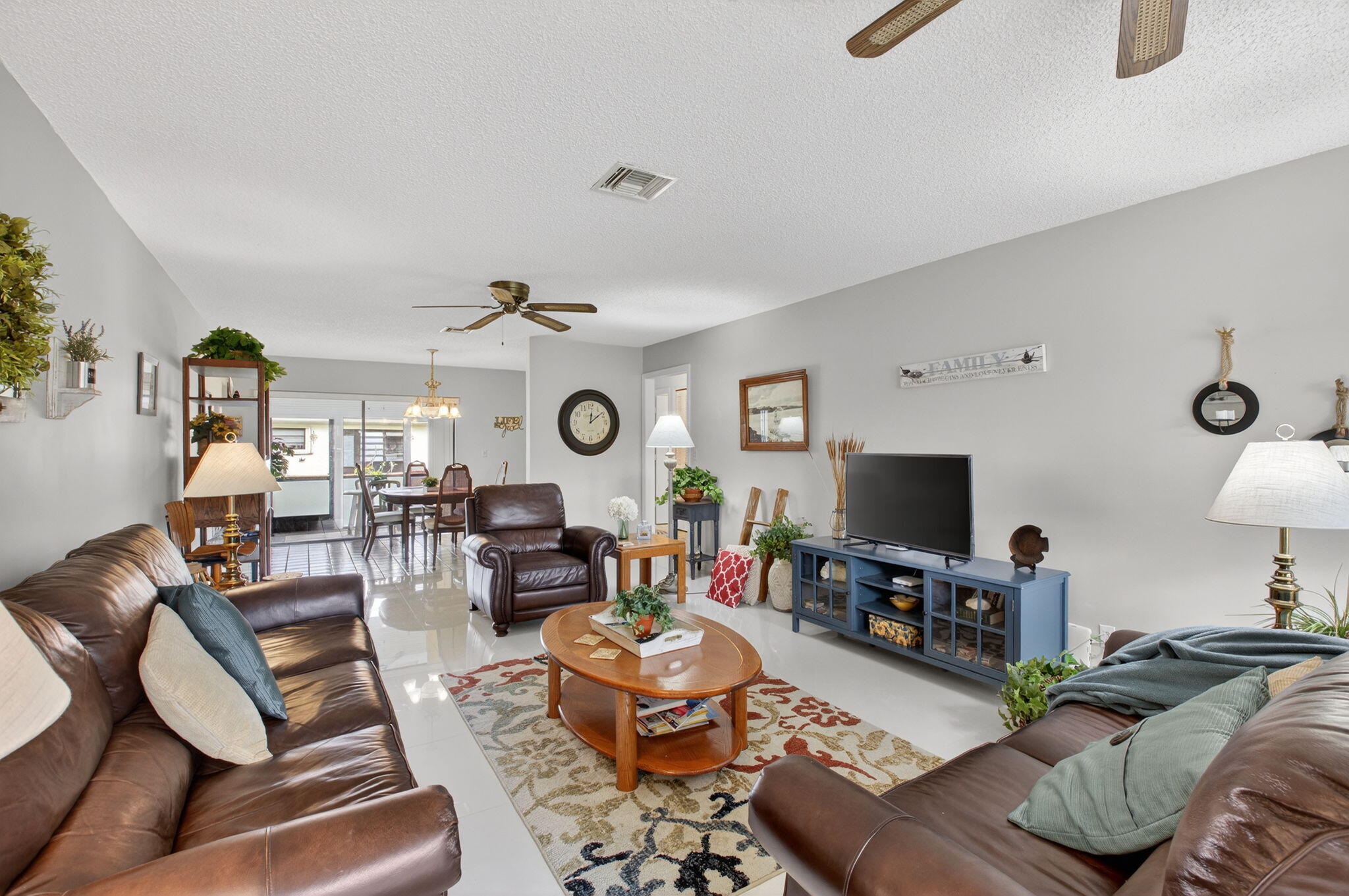 4972 Dovewood Road, Unit B Boynton Beach, FL 33436 - Photo 8 of 47 a living room with furniture and a flat screen tv
