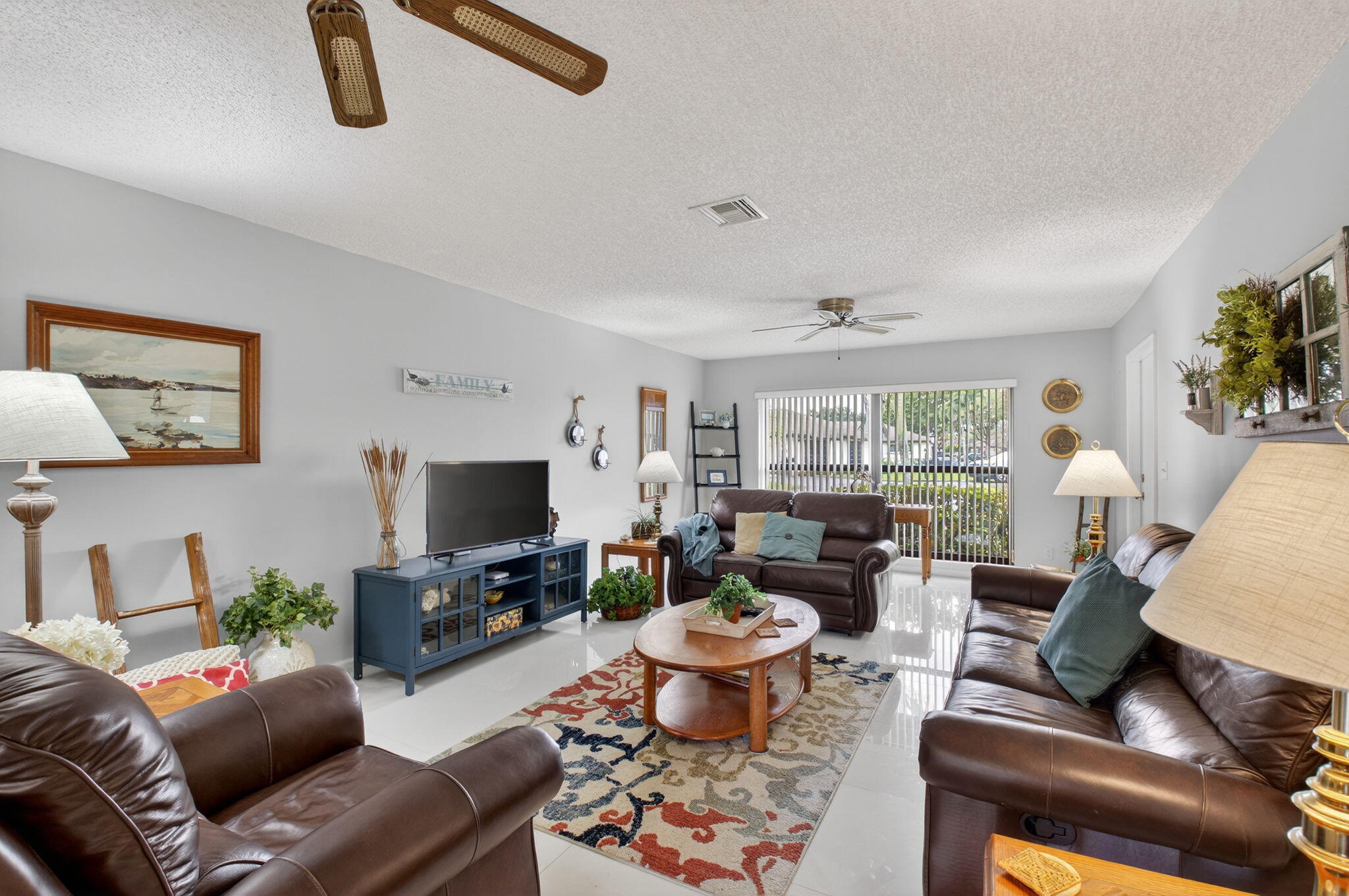 4972 Dovewood Road, Unit B Boynton Beach, FL 33436 - Photo 9 of 47 a living room with furniture and a flat screen tv