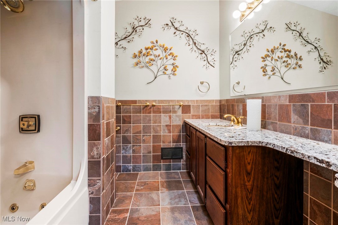 3290 State Rte 534 Geneva, OH 44041 - Photo 20 of 43 Bathroom with tile walls and vanity