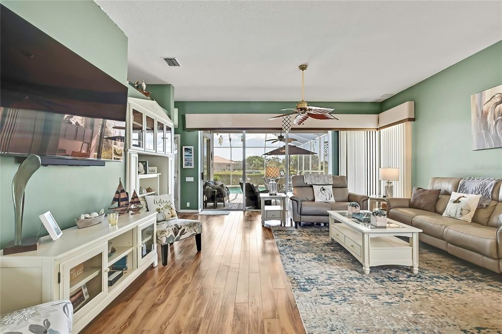 8472 Maybelle Drive Weeki Wachee, FL 34613 - Photo 14 of 58 a living room with furniture large window and wooden floor