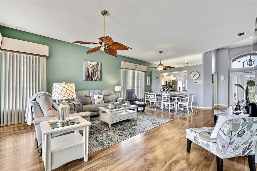 8472 Maybelle Drive Weeki Wachee, FL 34613 - Photo 15 of 58 a living room with lots of furniture and a wooden floor