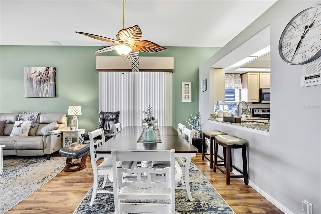 8472 Maybelle Drive Weeki Wachee, FL 34613 - Photo 17 of 58 a living room with furniture a rug and a chandelier