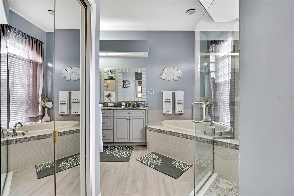 8472 Maybelle Drive Weeki Wachee, FL 34613 - Photo 26 of 58 a bathroom with a tub sink and mirror