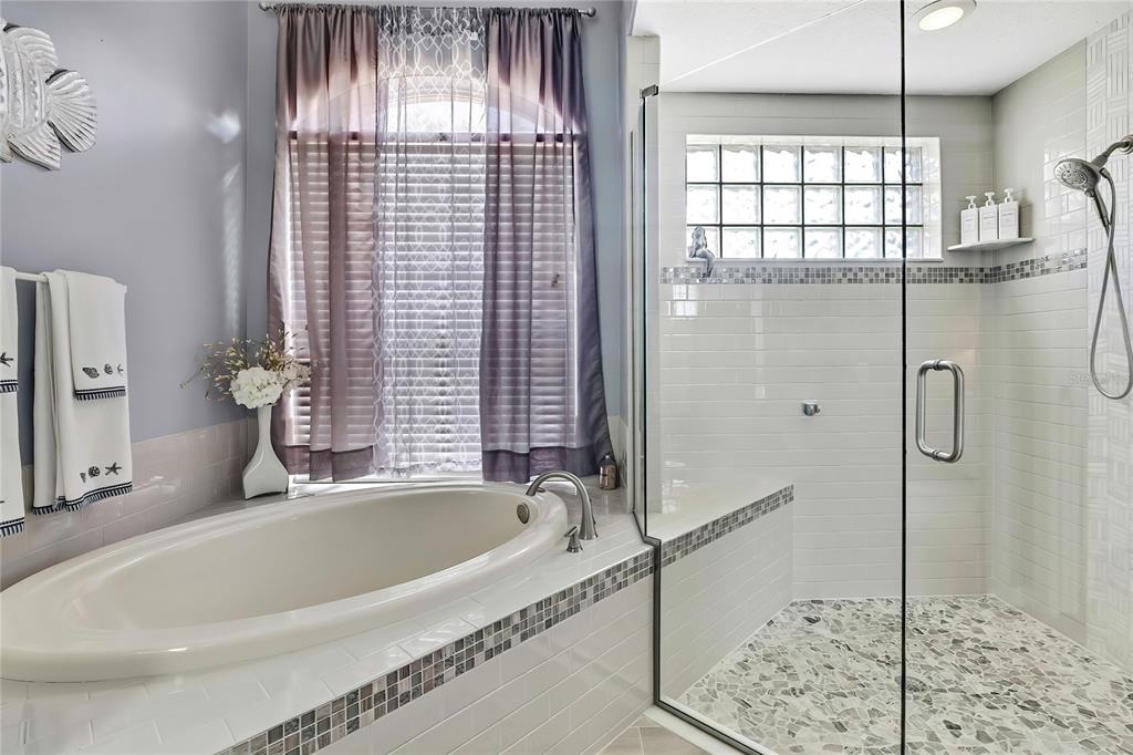 8472 Maybelle Drive Weeki Wachee, FL 34613 - Photo 30 of 58 a bathroom with a bathtub and shower