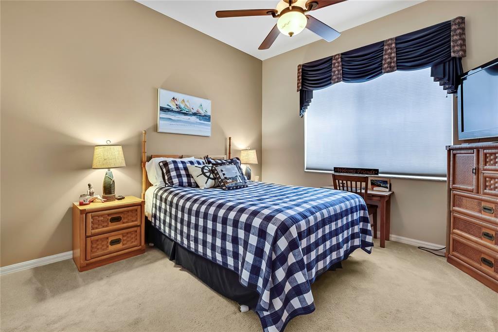 8472 Maybelle Drive Weeki Wachee, FL 34613 - Photo 32 of 58 a bedroom with a bed and a ceiling fan