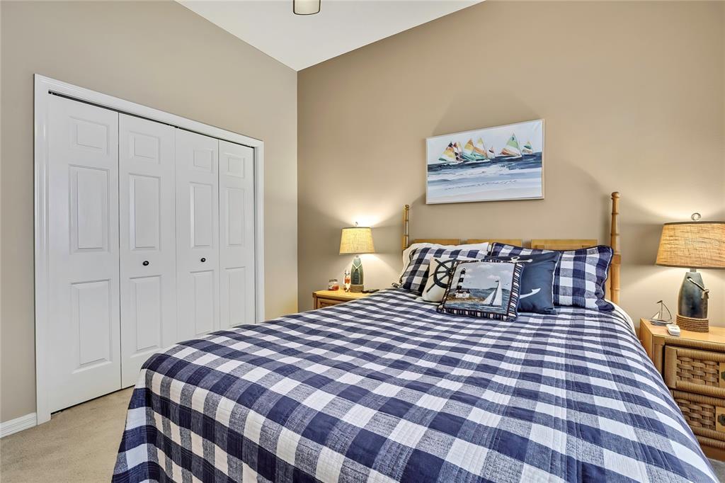 8472 Maybelle Drive Weeki Wachee, FL 34613 - Photo 33 of 58 a bedroom with a large bed and a lamp on dresser