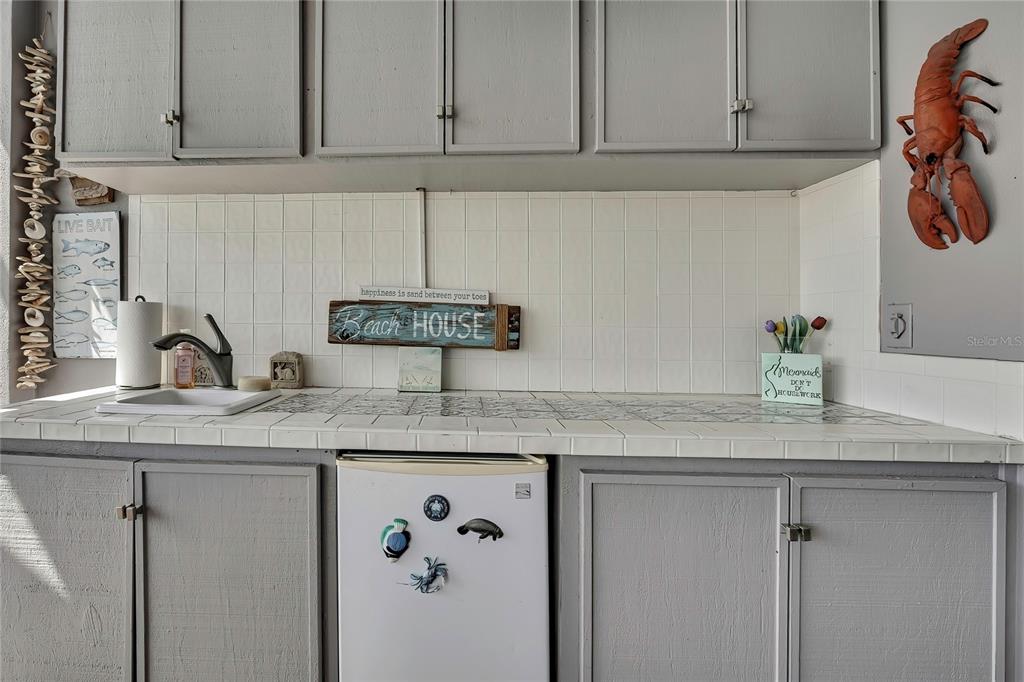 8472 Maybelle Drive Weeki Wachee, FL 34613 - Photo 38 of 58 a kitchen with stainless steel appliances granite countertop a sink a cabinets and a wooden floor