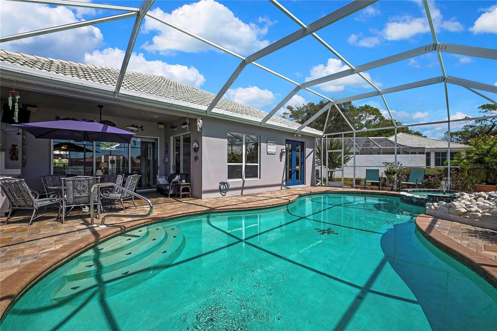 8472 Maybelle Drive Weeki Wachee, FL 34613 - Photo 41 of 58 a view of a patio with table and chairs under an umbrella