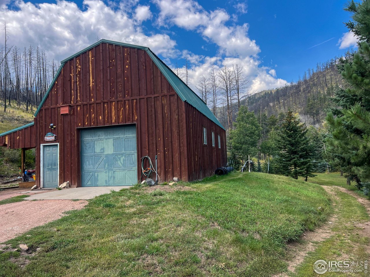 27667 Buckhorn Road Bellvue, CO 80512 - Photo 39 of 40 a view of a house with backyard and wooden fence