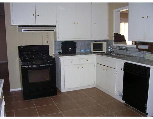 11217 Guess Drive Corpus Christi, TX 78410 - Photo 4 of 10 a kitchen with cabinets and appliances