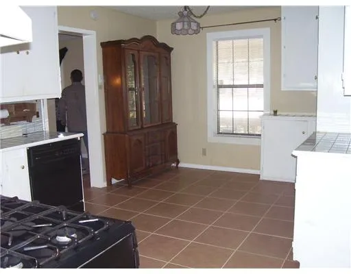 a kitchen with a refrigerator a stove and a window