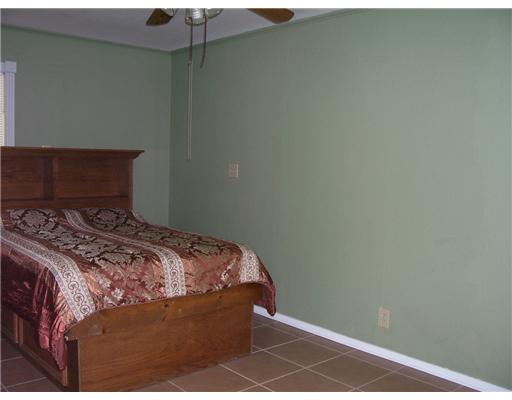 11217 Guess Drive Corpus Christi, TX 78410 - Photo 6 of 10 a bed sitting in a bedroom next to a window