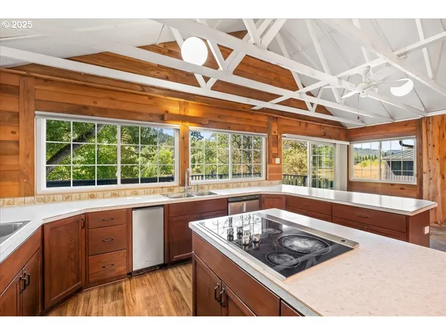 a kitchen that has a sink and a large window