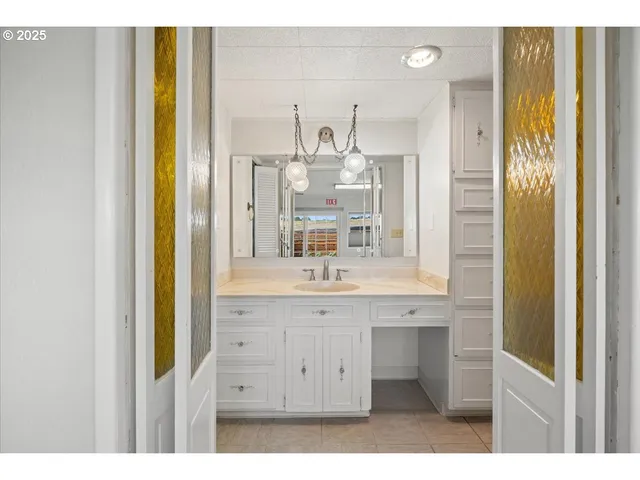 a bathroom with a granite countertop sink and a mirror