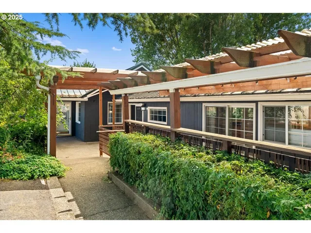 a house with lots of trees in the background