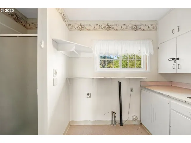 a kitchen with a refrigerator and a sink