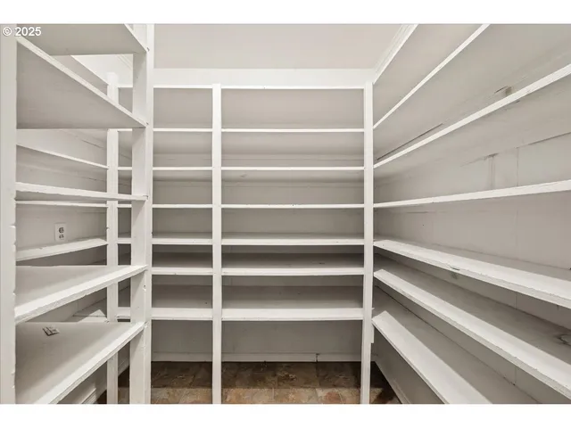 a view of walk in closet with empty racks