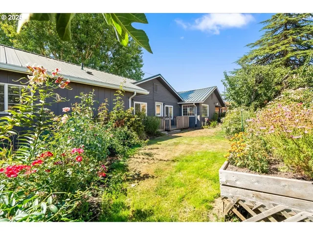 a view of a house with wooden fence