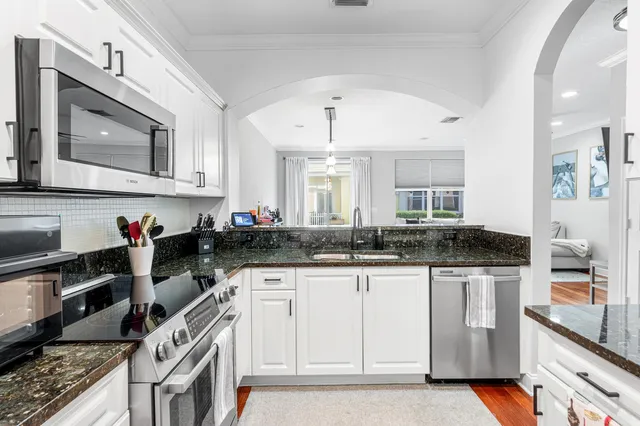 a kitchen with stainless steel appliances a refrigerator and a stove top oven
