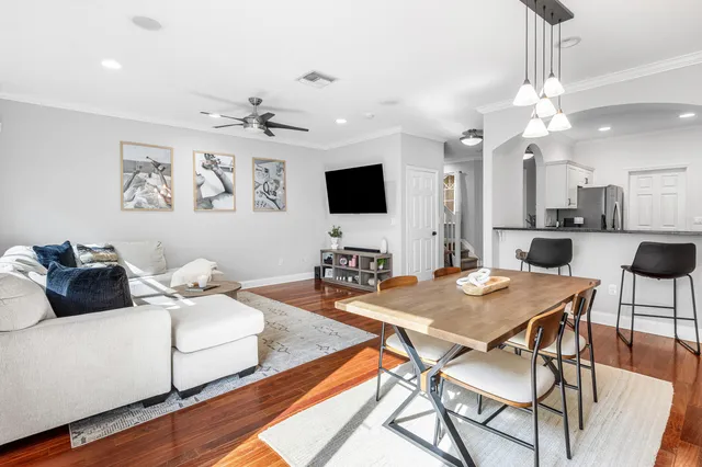 a living room with furniture and a chandelier