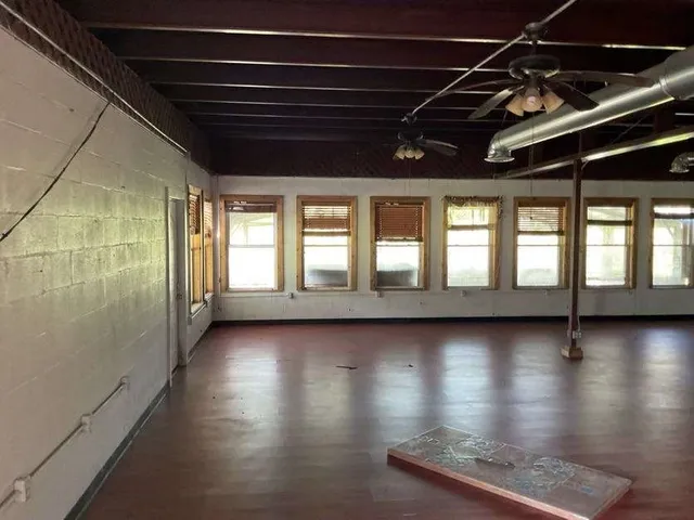 a view of room with window and wooden floor