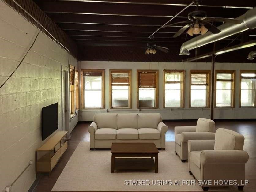 3303 St Anne Street Liverpool, TX 77577 - Photo 3 of 10 a living room with furniture a flat screen tv and a fireplace