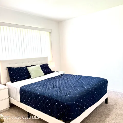 a bedroom with a large bed and a couch