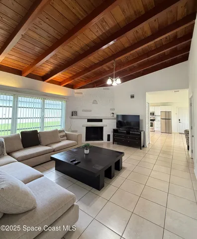 a living room with furniture a fireplace and a table