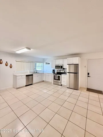a kitchen with cabinets and white appliances