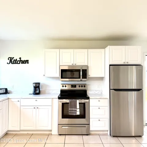 a kitchen with a refrigerator stove and microwave