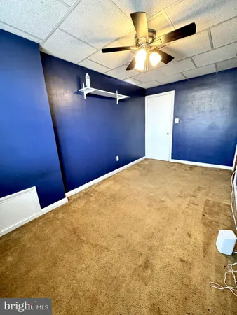 a view of a room with a ceiling fan
