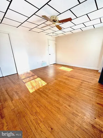 a view of a room with wooden floor