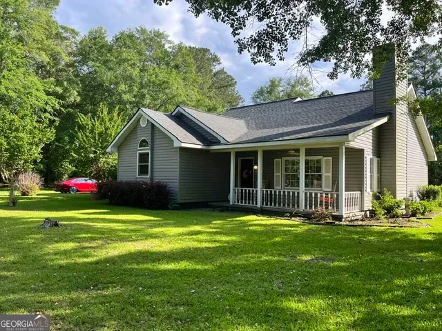 a front view of house with yard and green space